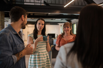 Group of colleagues having a discussion over a cup of coffee.