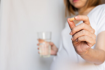 Pregnant woman are taking and eating vitamin medicine and drink water To nourish the pregnancy....