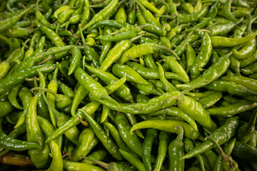Green chilli peppers at a market 