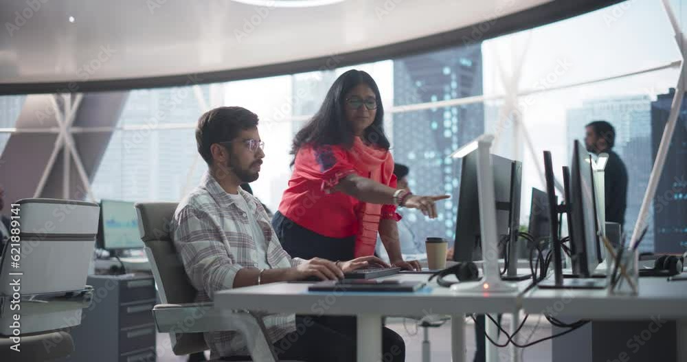 Poster portrait of two indian software developers discussing work in a technological corporate office. youn