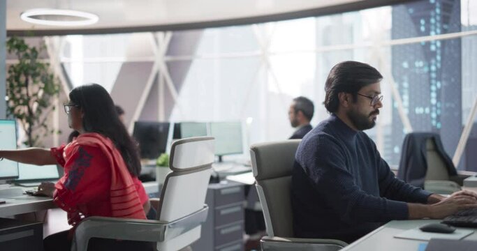 Team of Talented Young Indian Professionals Working in a Corporate Banking Firm. Team Leader Updating a Young Female Economic Strategist on Financial Stock Market News and Investment Trends