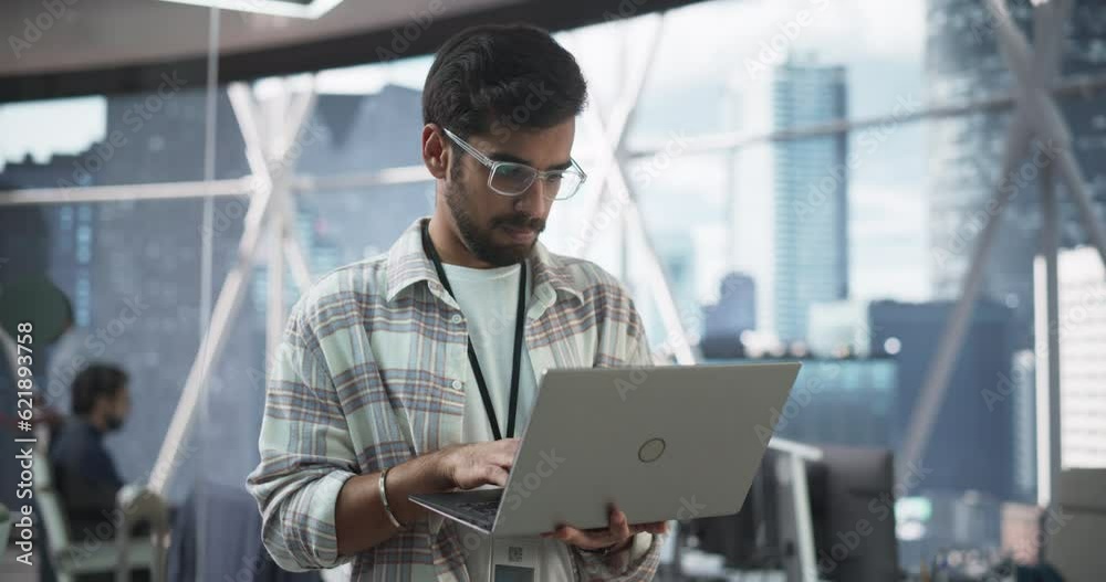 Aufkleber indian male business analyst standing with laptop computer in a modern office. successful man assess