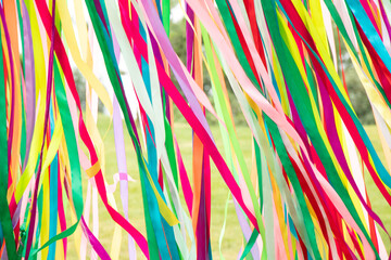 Multi-colored ribbons as a background fly in the window