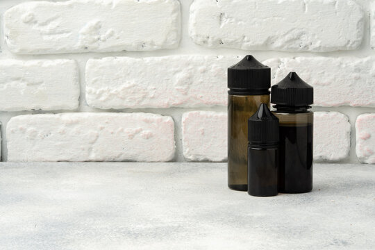 Refill liquid for electronic cigarettes against brick wall background