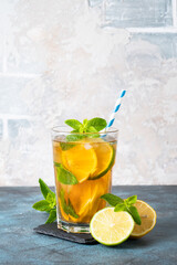 Fototapeta premium Iced tea with lemon, lime, mint and ice.