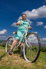 A woman on a bicycle in a lavender field. 