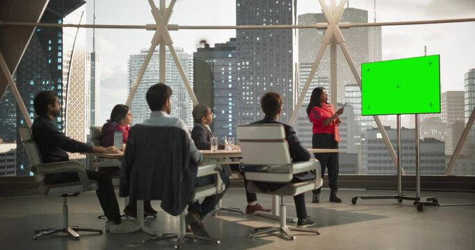 South Asian Businesswoman Shows Data to a Group of Indian Investors. TV Screen with Green Screen Mock Up Display. Business Meeting Presentation in Conference Room in Modern Office