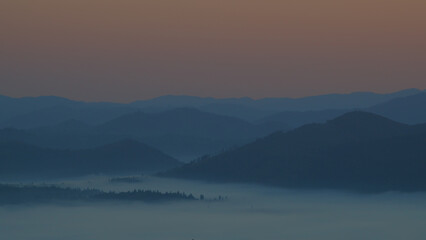 Carpathian mountains with fog at sunrise