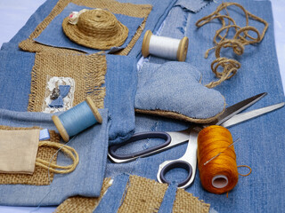 Handmade crafts from old blue denim and sewing accessories, recycling items of clothing.
