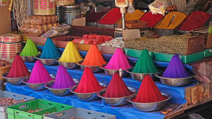 Rangoli powder, incense and joss sticks on display in an Indian market. The colourants are used in Hindu forehead marking and for festivals such as Holi as well as for making patterns, known as Kolams