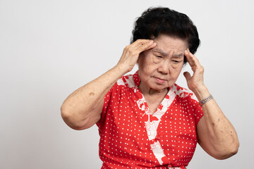A senior woman who has a severe headache suffers from a stroke ,brain disease,patient holding head...