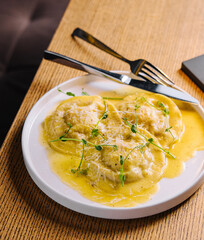 Tasty cooked ravioli with cheese sauce
