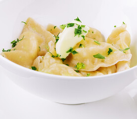 Delicious cooked dumplings and sour cream