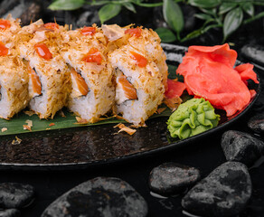 Closeup of sushi rolls on black plate