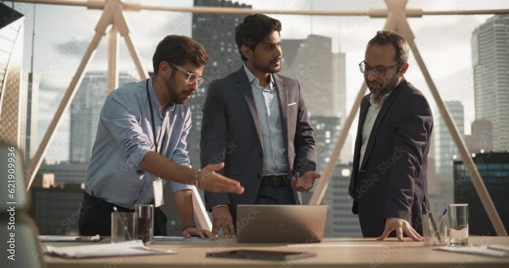 Aufkleber Young Indian Managers Discussing a Technological Business Solution for Their Fintech Startup. Businessmen Using a Laptop Computer and Having a Conversation About the Partnership Benefits