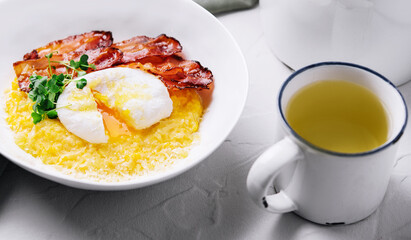 Fried bacon pieces and poached eggs on a plate