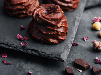 cakes in chocolate glaze on stone board
