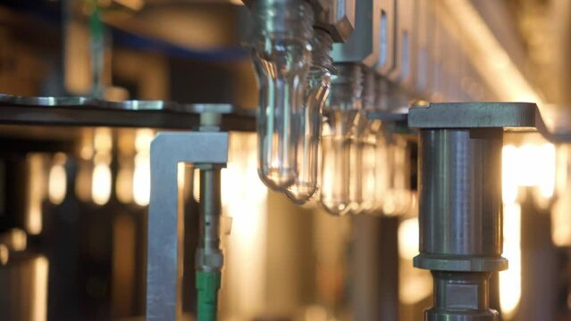 Raw shape of plastic water bottle on conveyor