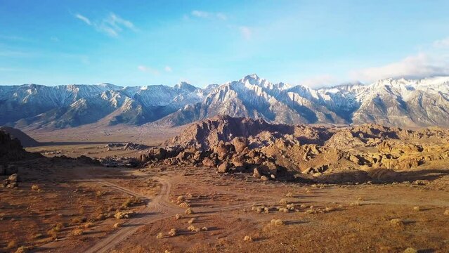 Aerial Backward Shot Of Scenic Mountains Against Sky, Drone Ascend Over Rocky Landscape - Alabama Hills, California