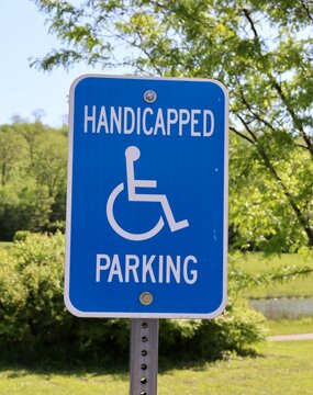 A close view of the blue and white handicap sign.