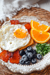 tosat with fried egg and bacon and Orange, Blueberry