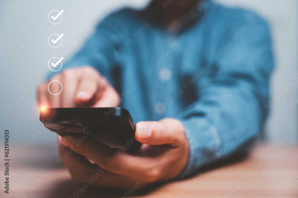 Poster Businessman use smartphone to tick correct sign mark in checkbox for quality document control checklist and business approve project concept.
