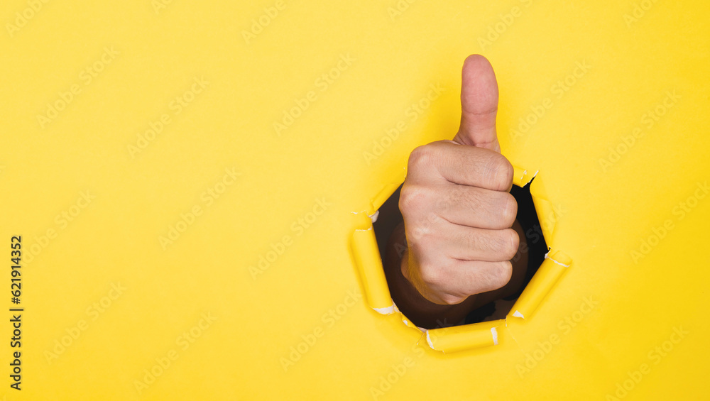 Poster businessman hand thumb up from yellow punched paper for client the best satisfaction evaluation surv