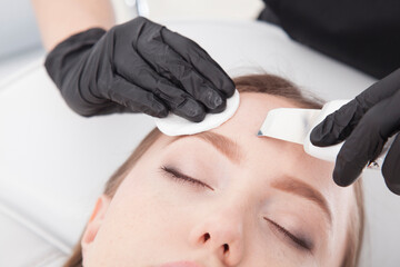 Patient of a beauty salon during facial treatments.