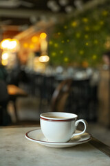 A cup of coffee on a table in a cafe