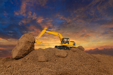 Crawler excavator is digging soil in the construction site  , With on  cloud and sky  background.
