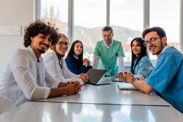 Happy multicultural medical team interacting at a meeting in conference room.