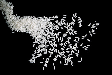 Raw white rice splash on black background. Uncooked rice explosion.