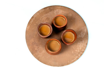 Fresh milk tea or indian karak chai or masala tea in clay cup on white background