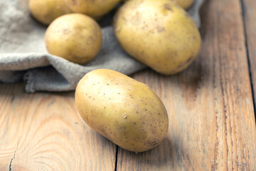 Close-up of ripe potatoes on a wooden background.