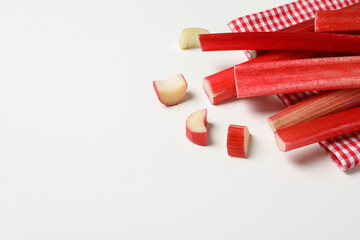 Rhubarb stalk on checkered towel on white background, space for text