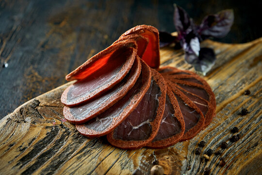 Pastirma or basturma on a wooden board with spices