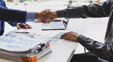 Business people shaking hands in a successful financial and investment cooperation meeting.