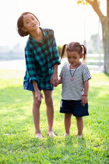 Fototapeta premium Profile view of cute kids run in park hold hands.SSTKHome