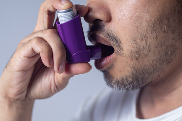 Asthma patient inhaling medication to treat Treatment of allergic asthma and the concept of chronic lung disease