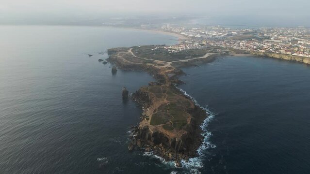 Aerial view of Peniche with Ilheu da Papoa island in foreground, a peninsula along the Atlantic Ocean coastline, Leiria, Portugal.