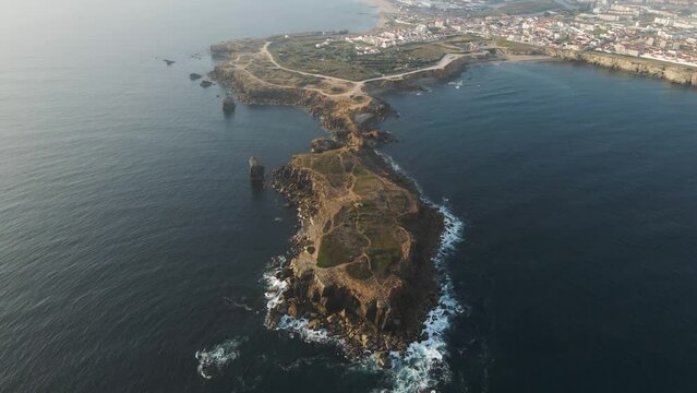 Aerial view of Peniche with Ilheu da Papoa island in foreground, a peninsula along the Atlantic Ocean coastline, Leiria, Portugal.