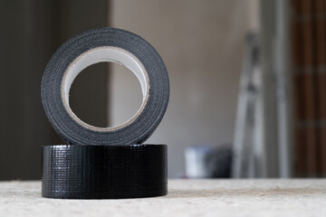 Duct tape repair tape. Reel of universal black fabric adhesive tape.
