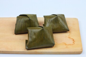 Nagasari or Nogosari cake on a white tray is a type of traditional wet cake that is very popular and passed down from generation to generation in Javanese society.