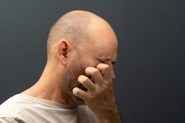 Man in his 50s, emotionally shaken showing stress or pain gesture. Feeling weak or depressed.
