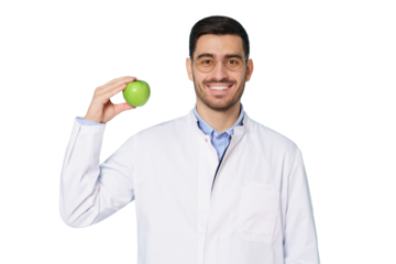 Smiling nutritionist or dentist doctor wearing white coat and round glasses, showing green apple with hand