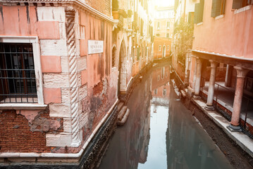 Narrow canal in Venice, Italy with boats