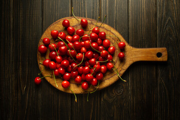 Ripe cherries on a kitchen board. A stack of cherry before sorting and cooking on the kitchen table
