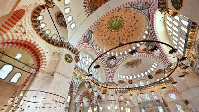 Interior view of the Suleymaniye mosque in Istanbul, Turkey. A lot of illumination, painted ceiling