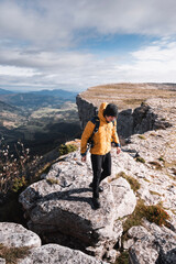 mountaineer on the rocks by the spectacular landscape of Aro and Eskutxi of the mountain range of Gorobel or Sierra Salbada in Alava