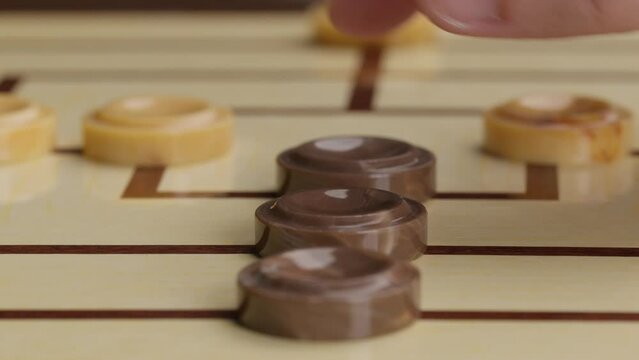 Hand Playing Nine Men Morris Board Game